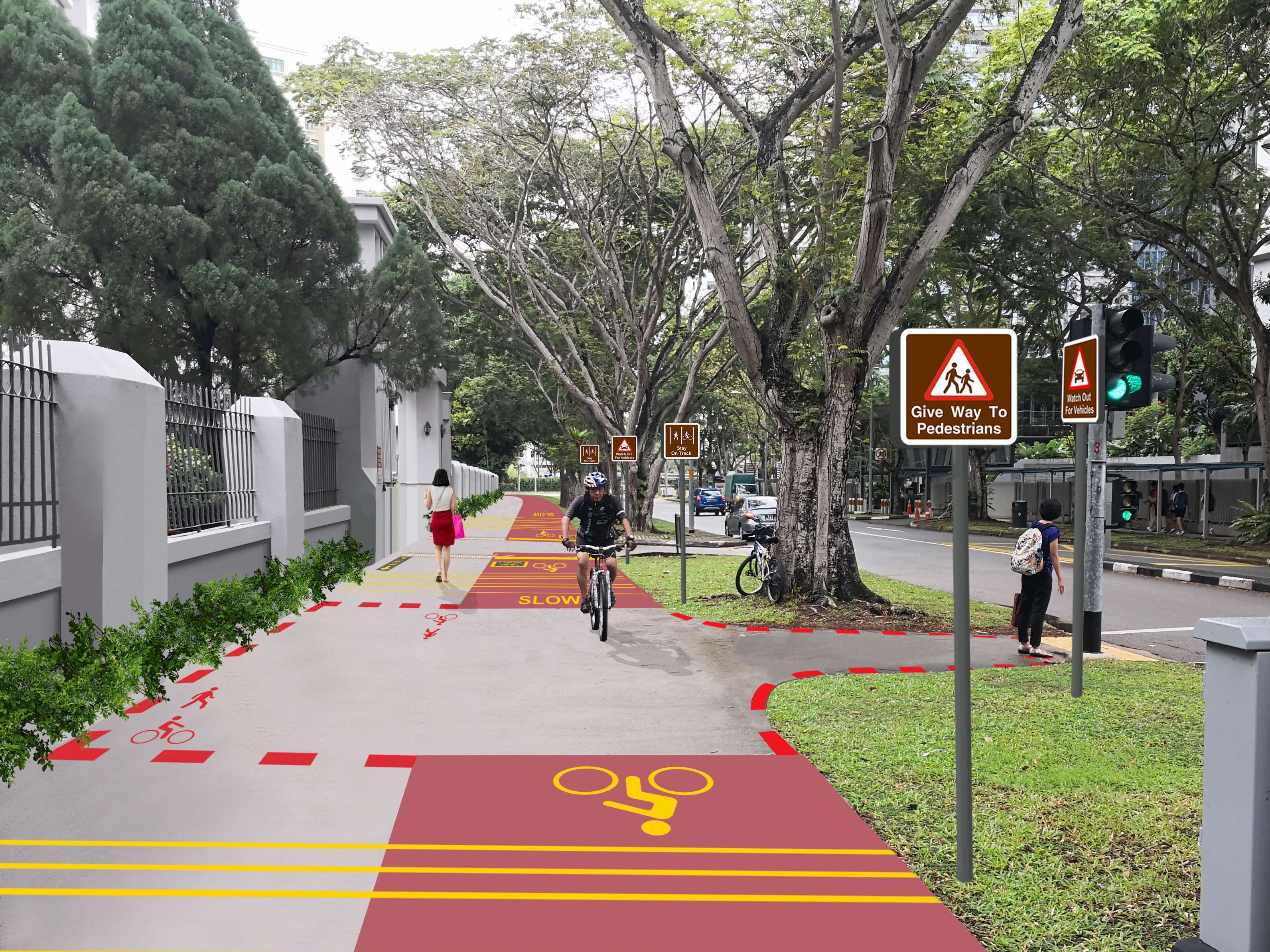 Street scene with shared pedestrian/bicycle path. Red path with yellow bike symbols; signs for pedestrians and cyclists.